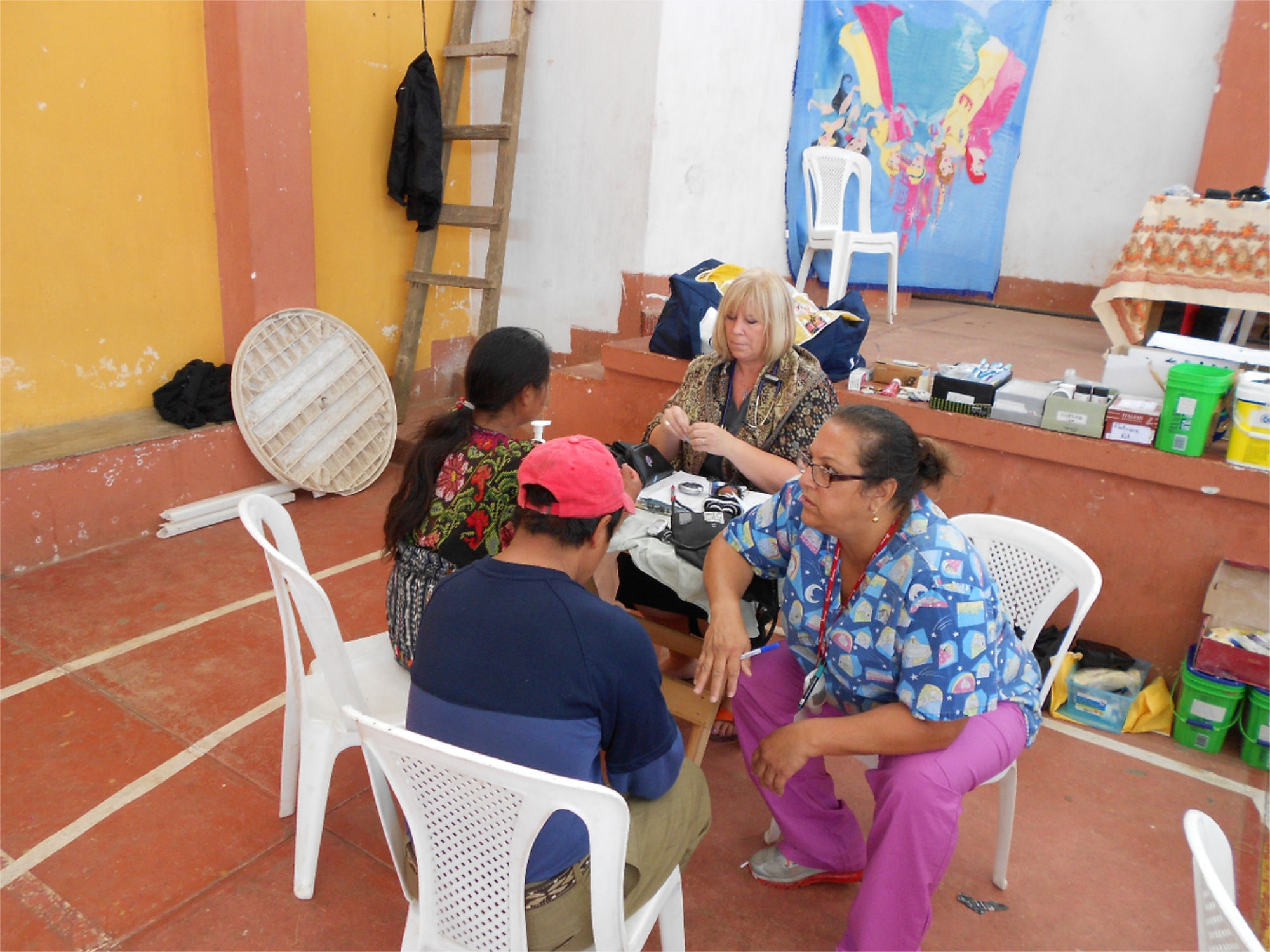 Two nurses talking to two patients 